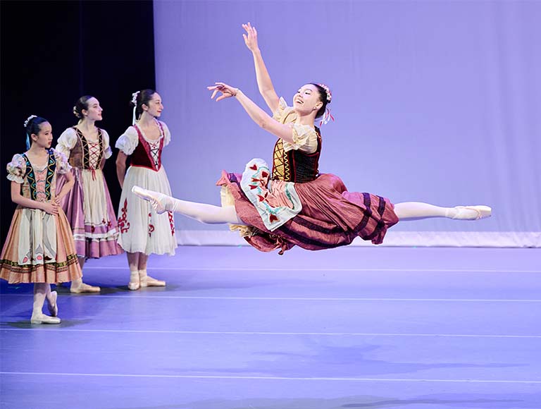 Ballet Eclectica dancer leaping in TRIumphant