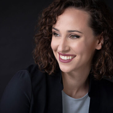 Headshot of Audrey Johnston on black background