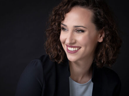 Headshot of Audrey Johnston on black background