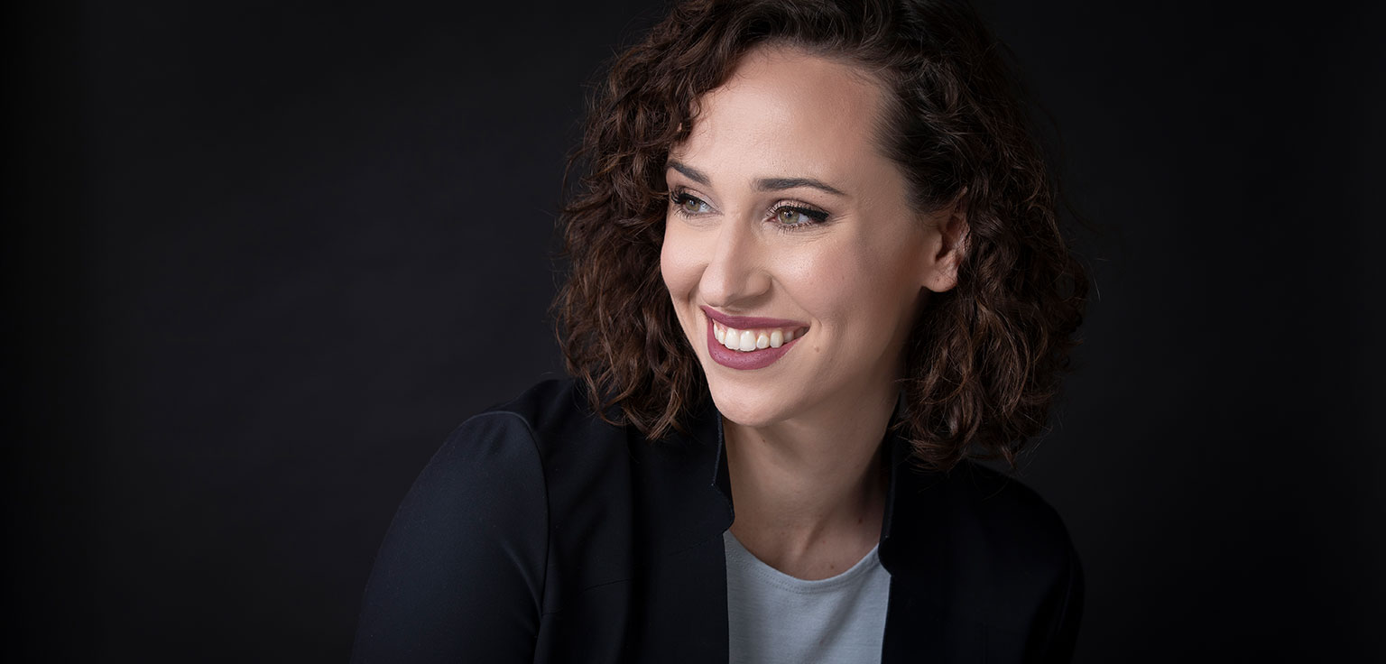 Headshot of Audrey Johnston on black background