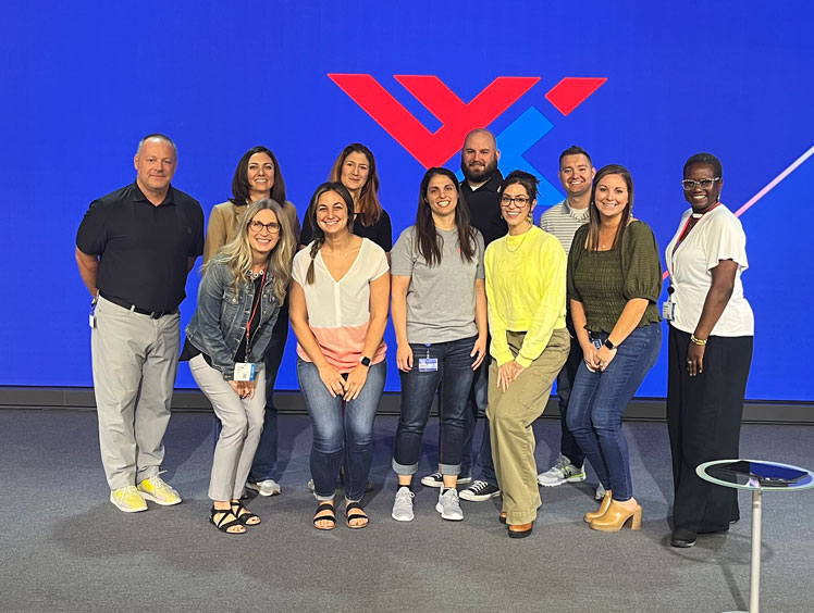 Group of participants from COCAbiz Workshop standing in front of blue background