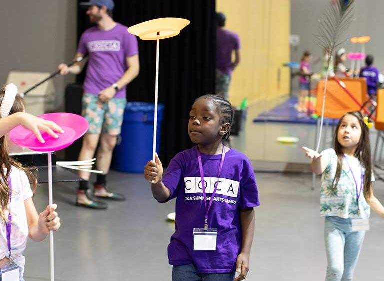 COCA camper in purple shirt in circus camp