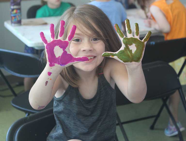 Discover-COCA-Day Student in art class with paint on hands